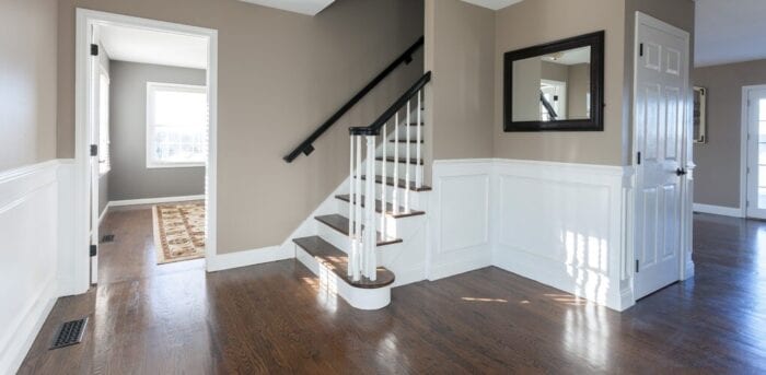 empty hall way with brown walls and white doors
