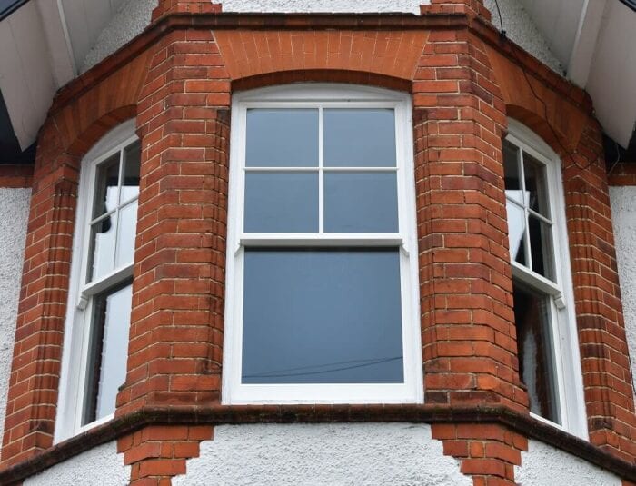 brick house with a white rimmed window